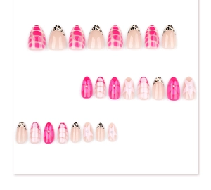 Flat lay of short almond press-on nails with pink leopard, star patterns and pearls