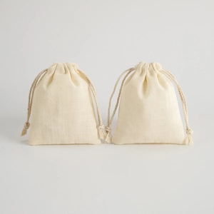 Dual cream cotton linen drawstring pouches for jewelry storage with woven texture