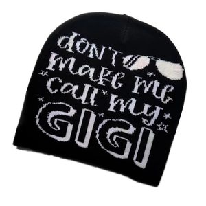 Detail of black knit beanie featuring white Don't Make Me Call My Gigi lettering