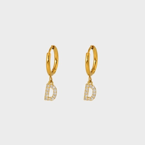 Detailed close-up of gold plated earring featuring a crystal-encrusted letter D charm