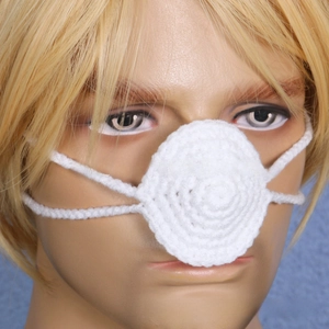 Detail of a handmade white crocheted nose warmer on a mannequin with blue background