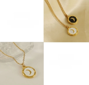 Macro view of moon pendant detail on golden titanium steel necklace with enamel inlay