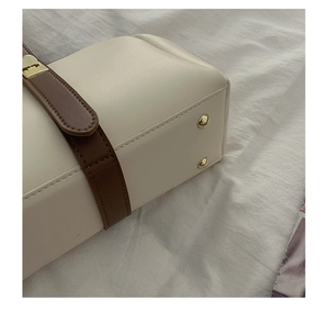 Detail of bag bottom with protective gold studs and contrast leather texture