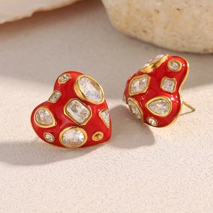 Detailed macro view of 18K gold plated heart earrings with red enamel and clear zircons