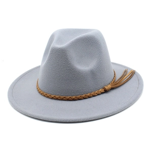 Detail of light gray wool fedora hat with brown braided leather band and tassel accents