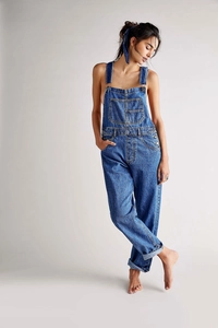 Detail of dark blue denim overalls featuring metallic buckles and contrast stitching
