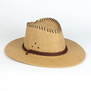 Detail of straw cowboy hat with braided decorative rope and breathable metal eyelets