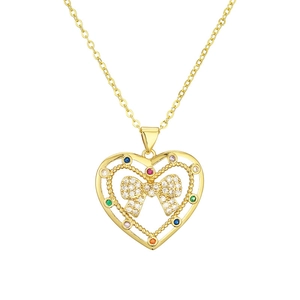 Golden heart pendant necklace with colorful gems and zircon-encrusted bow on white background