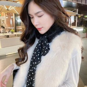 Detail of leopard faux fur scarf with polka dot ribbon bow and soft plush texture