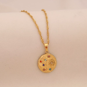 Detail view of gold moon star pendant necklace with colorful cubic zirconia crystals