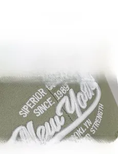 Detail of olive green baseball cap with premium 3D white embroidered New York lettering