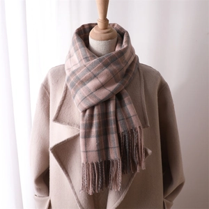 Pink and grey checkered cashmere-feel scarf with tassels on wooden mannequin