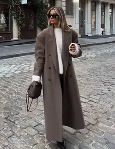 Detail of a brown double-breasted long wool coat with large lapels and textured finish