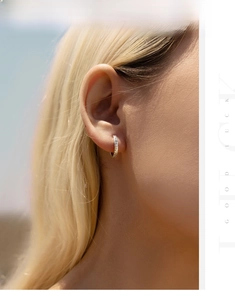 Close-up of S925 sterling silver hoop earrings with star texture on a model's ear