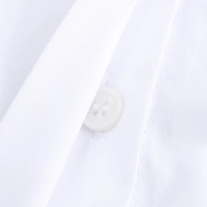 Detailed close-up of white commuter shirt collar with premium white button and cotton texture