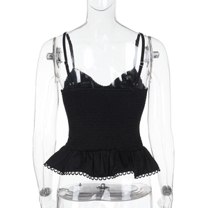 Close-up of the black corset top with a smocked back and elegant ruffled hemline
