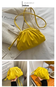 Detailed macro view of vibrant yellow soft PU leather handbag with elegant pleat textures