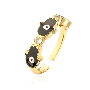 Detailed macro view of 18K gold plated Hamsa hand ring with black enamel and zircon accents