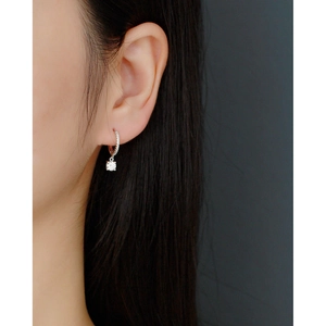 Close-up of geometric S925 sterling silver hoop earring with sparkling zircon pendant