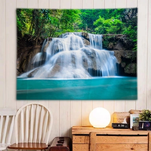 Detail of wall tapestry showing a nature waterfall landscape in a cozy bedroom setting