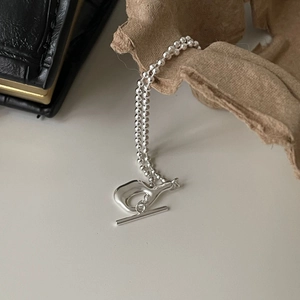 925 sterling silver irregular bead necklace with T-bar clasp on rustic paper background