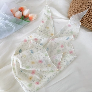 Detail view of floral print polyester scarf with delicate pink and yellow flowers
