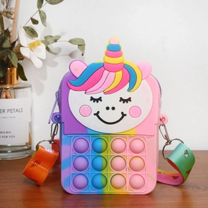 Rainbow unicorn silicone pop-it crossbody bag for kids with printed strap on wood surface