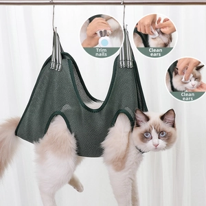 Detail of green mesh pet grooming hammock showing nail trimming and ear cleaning use