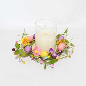 Easter candle holder with glass cup, colorful daisies and speckled eggs on floral wreath