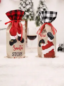 Detail of burlap Christmas wine bags with Santa Claus graphics and red ribbon closure