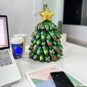 Christmas tree foil balloon centerpiece with gold star and festive holiday patterns