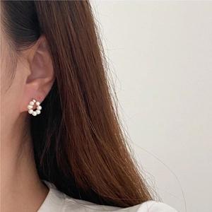 Elegant 925 sterling silver wreath earrings with small pearls on a female model
