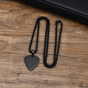 Polished black stainless steel guitar pick pendant necklace on wooden surface