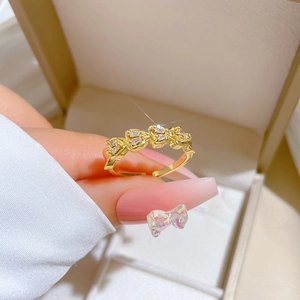Adjustable gold plated ring with double row crystals displayed on a jewelry box