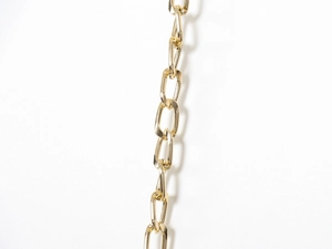 Close-up detail of polished gold metal chain links with professional glossy finish