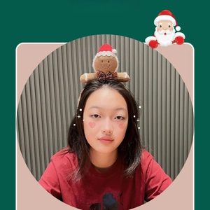 Plush gingerbread man Christmas headband with red hat and checkered bow detail
