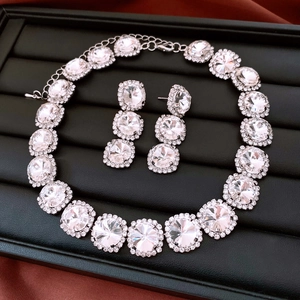 Macro detail of luxury silver necklace and earring set with round crystal gemstones
