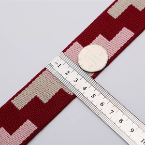 Adjustable wide replacement bag strap with red and grey geometric knit wave pattern