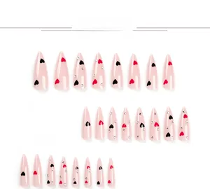 Detail of 24pcs pink stiletto fake nails with red hearts and silver rhinestones