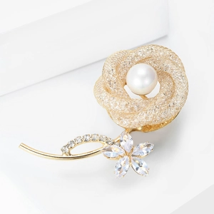 Elegant gold mesh rose brooch with pearl center and sparkling rhinestone petals