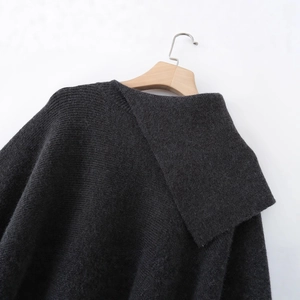 Women's dark gray knit cape coat with asymmetric lapel collar on wooden hanger
