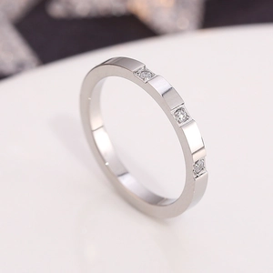 Sleek silver titanium steel ring featuring three inlaid diamonds for a minimalist look