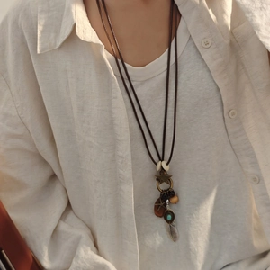 Bohemian multilayer sweater necklace with feather, star charms and beads on model