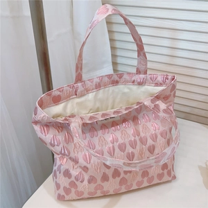 Close-up of pink heart jacquard tote bag showing fabric texture and spacious interior