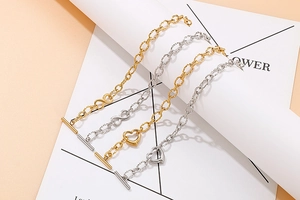 Detail of stainless steel charm bracelets with heart pendants and T-bar toggle clasp