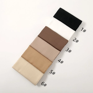 Detail view of cotton linen hijabs in black, white, brown and khaki neutral colors