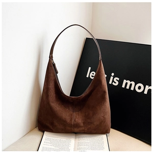 Detailed macro view of the brown frosted suede texture on a large hobo shoulder bag