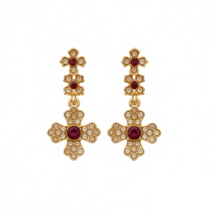 Vintage gold cross earrings with dark red and white crystals on a white background