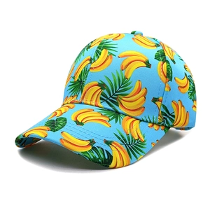 Detail view of light blue baseball cap featuring realistic banana and tropical leaf print