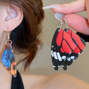 Detailed view of lightweight acrylic butterfly wing earrings with vibrant color patterns